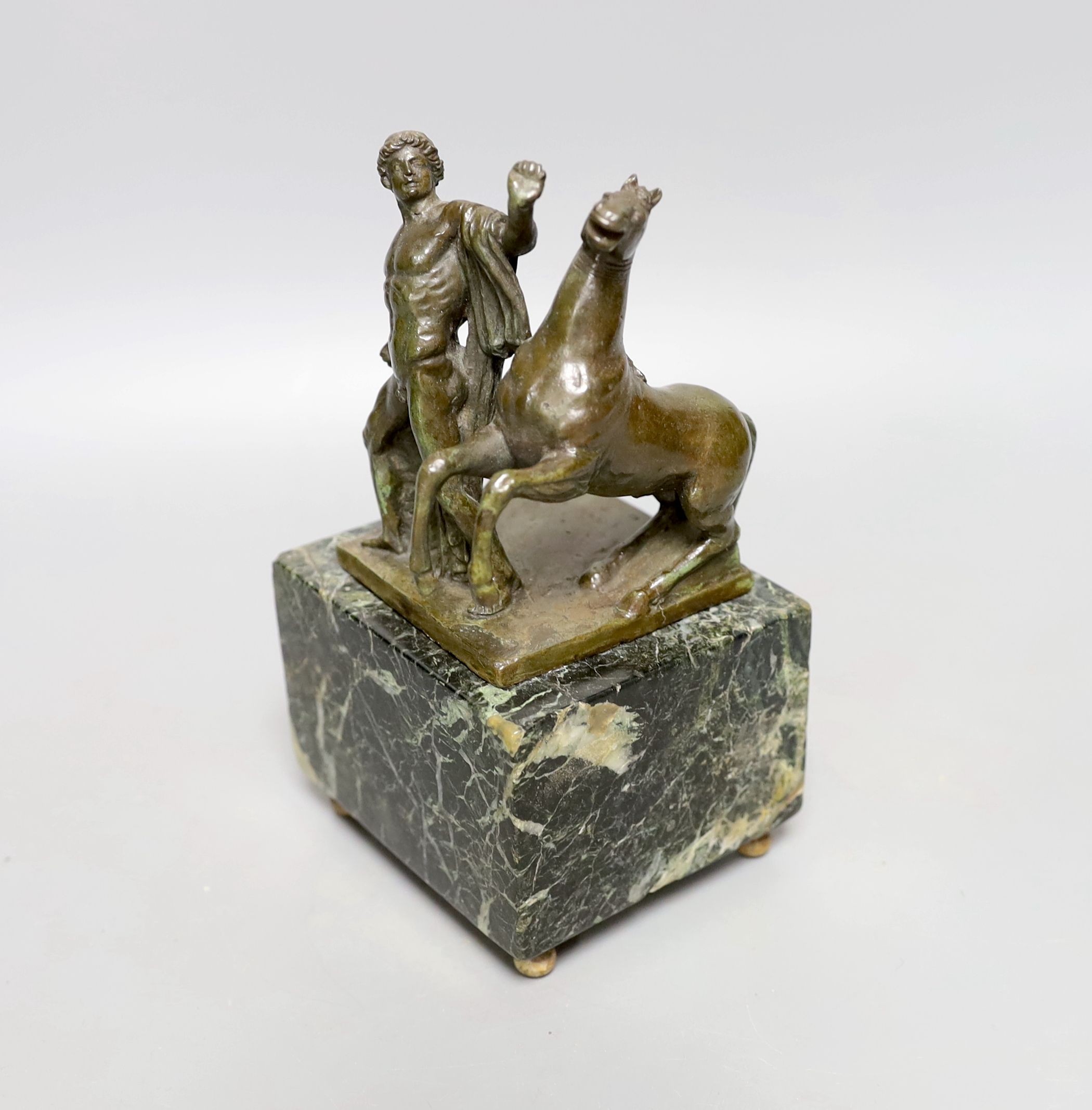 A Roman style bronze of a man and horse on a marble base 17cm